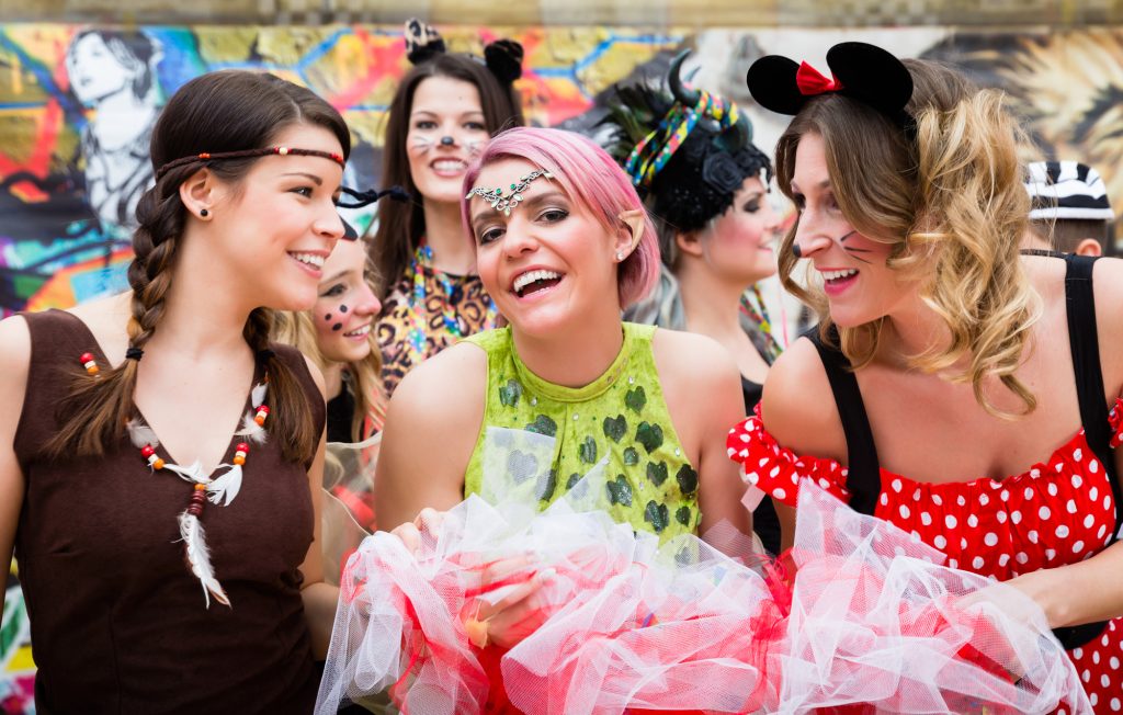 Group Of Women In Sexy Costumes At Carnival Party